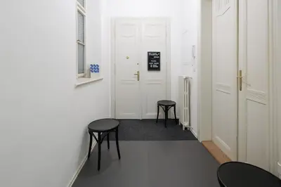 a hallway with two stools and a white door at Best Place in Prague in Prague