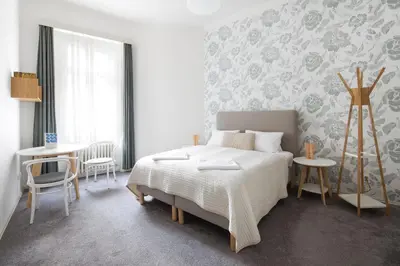 a bedroom with a bed and a table and chairs at Best Place in Prague in Prague