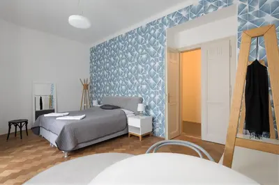 a bedroom with a bed and a blue wall at Best Place in Prague in Prague