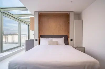 a small bedroom with a bed and a kitchen at City Pop 2Night Prague - Self check-in in Prague