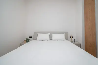 a living room and kitchen with a couch and a table at City Pop 2Night Prague - Self check-in in Prague