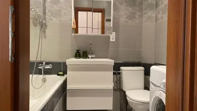 a living room with a couch and a bar with stools at Apartmán v centru Prahy in Prague