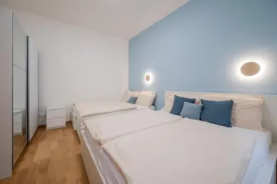 a hallway with white cabinets and a staircase in a house at Seifertova Apartments by Willstay in Prague