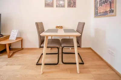 a kitchen with green cabinets and a wooden door at Seifertova Apartments by Willstay in Prague