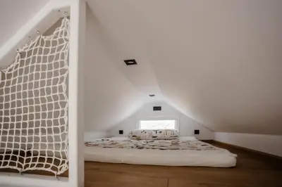a bedroom with a bed in a attic at Glamping Osada in Hyskow