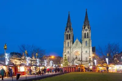 a church with a christmas market in front of it at night at Soukromý pokoj v rodinném domě in Prague