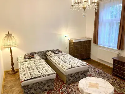 a bedroom with two beds and a window at Soukromý pokoj v rodinném domě in Prague
