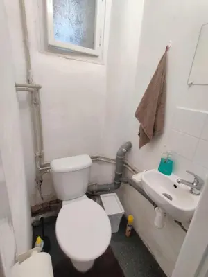 a small kitchen with a sink and a counter at Apartment in house with private parking and garden in Prague
