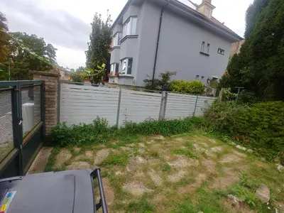 a stairway leading up to a building with a red pole at Apartment in house with private parking and garden in Prague