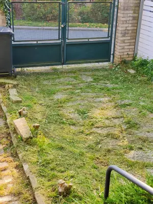 a white fence in front of a white house at Apartment in house with private parking and garden in Prague