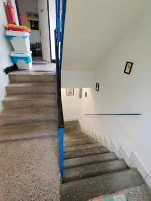 a staircase with a baseball bat in a room at Apartment in house with private parking and garden in Prague