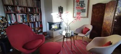 a living room with two chairs and a fireplace at Guestrooms, rooftop with garden, spacious living room, character and fireplace in Prague
