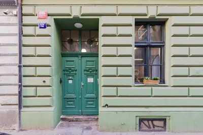 a green door on a building with a window at LOFT Apartments in Prague