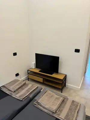 a living room with a tv and a couch at Cool Vitkova apartment with balcony in Prague