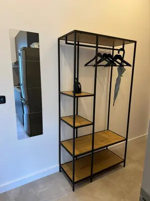 a glass shelf in a kitchen with a refrigerator at Cool Vitkova apartment with balcony in Prague