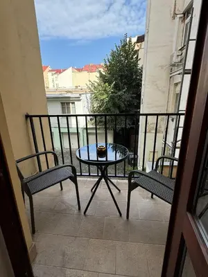 a patio with a table and two chairs on a balcony at 1 Bed Flat - Sleeps 2 - Pets - Smoking on terrace in Prague