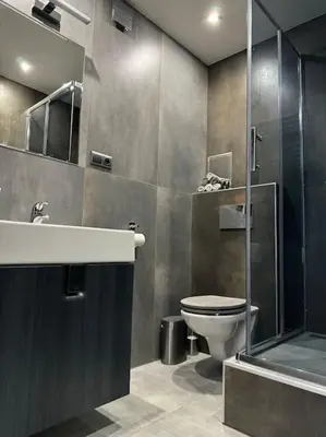 a bathroom with a toilet and a shower and a sink at Offspa privátní wellness in Prague