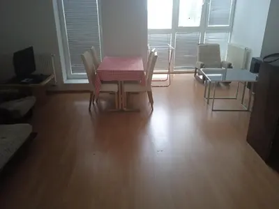 a dining room with a table and chairs in a room at Byt Vinoř in Prague