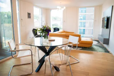 a living room with a glass table and chairs at Residence 60 free parking&wifi in Prague