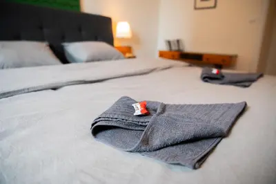 a pair of towels sitting on top of a bed at Residence 60 free parking&wifi in Prague