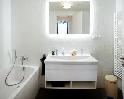 a white bathroom with a sink and a bath tub at Residence 60 free parking&wifi in Prague