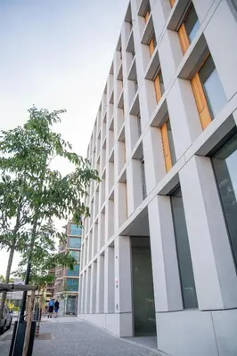 a tall white building with a tree in front of it at Residence 60 free parking&wifi in Prague