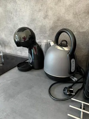 a tea kettle with headphones sitting on a counter at Apartmán 1 Jägerhaus in Radovesice