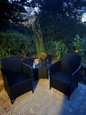 two chairs and a coffee table on a patio at Apartmán 1 Jägerhaus in Radovesice