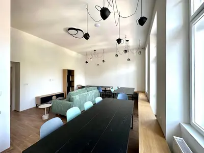 a living room with a table and a couch at Onefam Arbes in Prague