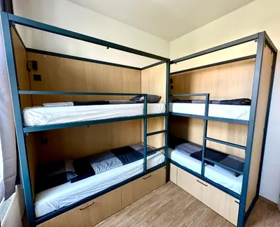 a room with three bunk beds in it at Onefam Arbes in Prague