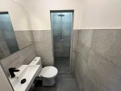 a bathroom with a shower and a toilet and a sink at Onefam Arbes in Prague