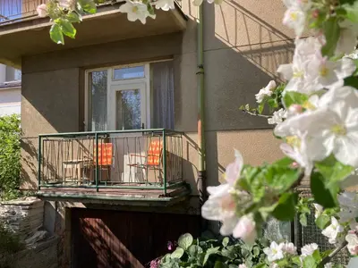a balcony on a house with chairs on it at Spacious apartment - free parking! in Prague