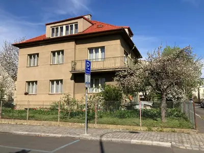 a building on the side of a street with a sign at Spacious apartment - free parking! in Prague
