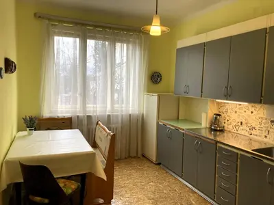 a kitchen with a table and a table and a window at Spacious apartment - free parking! in Prague