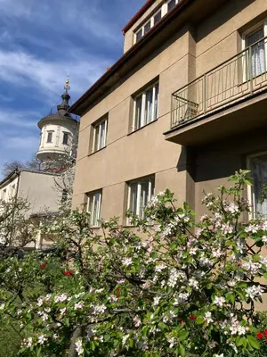 a building with a clock tower on top of it at Spacious apartment - free parking! in Prague