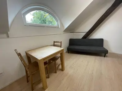 a living room with a couch and a table at Hotel Vinařice Česky kras in Měňany