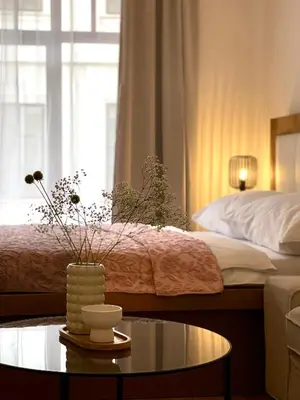 a living room with a bed and a table with a coffee table sidx sidx sidx at Powder Tower Residence in Prague