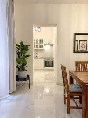 a living room with a table and a potted plant at Powder Tower Residence in Prague