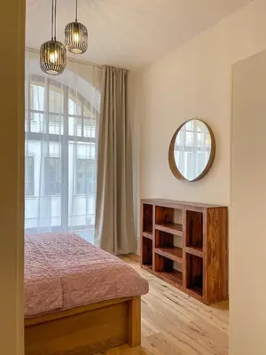 a bedroom with a bed and a mirror at Powder Tower Residence in Prague