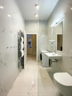 a bathroom with a sink and a toilet and a mirror at Powder Tower Residence in Prague
