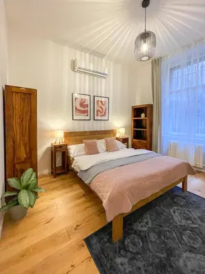a bedroom with a large bed and a large window at Powder Tower Residence in Prague