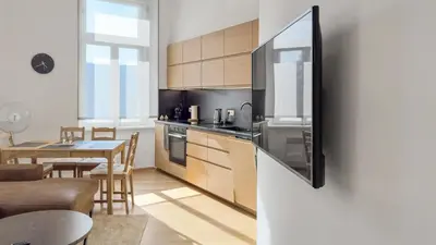a kitchen with a table and a dining room at Nebeský apartmán in Prague