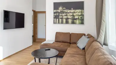 a living room with a couch and a table at Nebeský apartmán in Prague