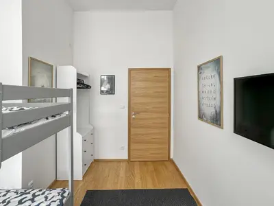 a bedroom with a bunk bed and a television at Nebeský apartmán in Prague