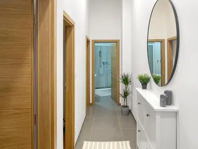 a bathroom with a mirror and a walk in shower at Nebeský apartmán in Prague