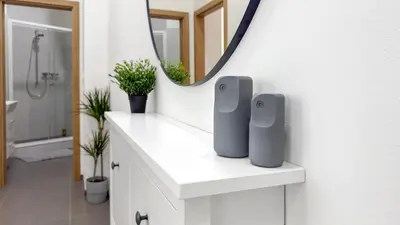 a bathroom with a white counter with a mirror at Nebeský apartmán in Prague