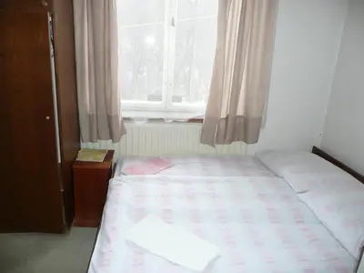 a small bedroom with a bed and a window at Apartment Trojska in Prague
