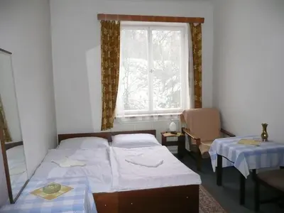 a bedroom with two beds and a window at Apartment Trojska in Prague