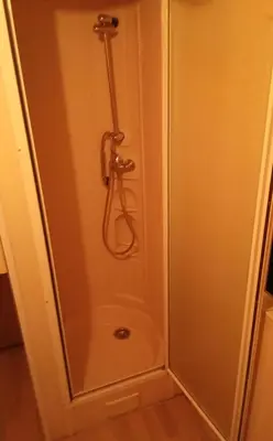 a shower stall in a bathroom with a shower at Pobřežní chatička Marta in Sázava