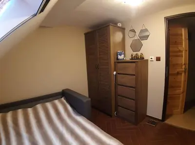 a room with a dresser and a mirror and a hallway at Cottage Nova in Živohošť